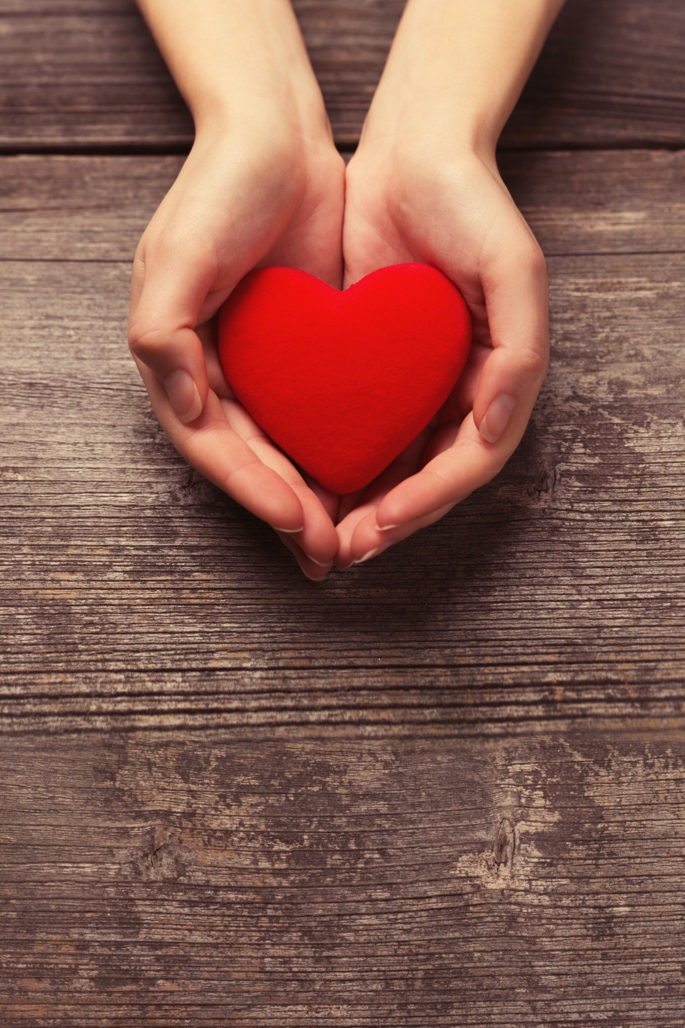 Hands holding a red heart